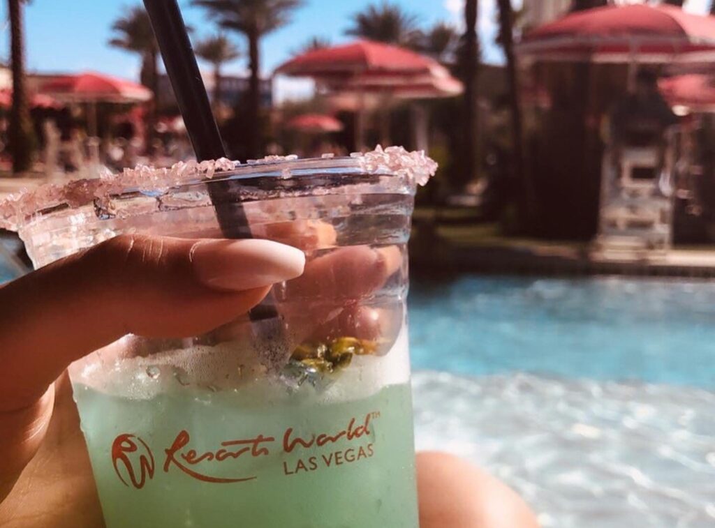 a womans hand holding a green frozen cocktail, resorts world las vegas